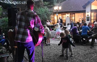 Guests enjoying outdoor live music at Live at the Lodge