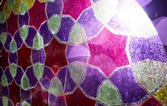 Light shining through colours, with pink stars