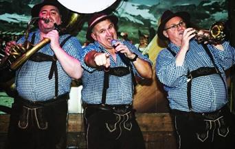 Three men dressed in Lederhosen