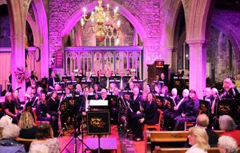 Members of the Worle Wind Band performing in a church