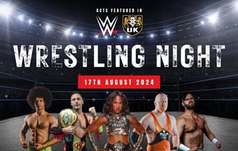 A photocall of five wrestlers in a wrestling ring all facing forward at the camera
