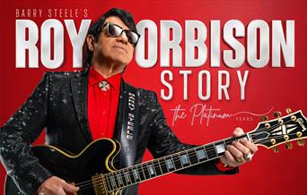Red poster advertising the Roy Orbison Story at the Weston Playhouse. The poster features a guitarist looking like the singer