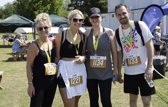 Mendip Challenge participants with their medals and walking numbers stood at Weston Cricket Club.