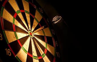 Dartboard with a dart in the bullseye