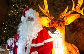 Father Christmas with a lit up model reindeer