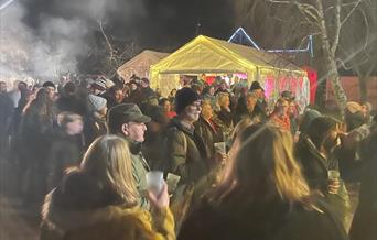 Crowds of people around an apple tree