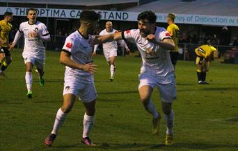 Football players looking happy on the pitch