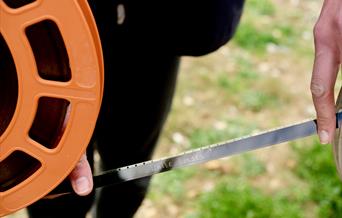 Reel of film, writing on the film are the words 'White Horses