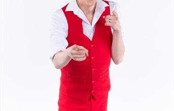 Comedian wearing red waistcoat and trousers