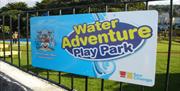 Sign on the railings saying Water Adventure Playpark