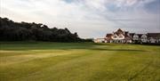 A view towards the side of residential flats at the north end of the course