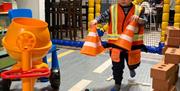 Child playing road builder putting traffic cones out