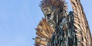 A statue depicting an angel which has been made out of knives and blades