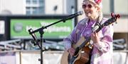 Guitarist and singer Phoebe performing at the weekly Weston-super-Mare market