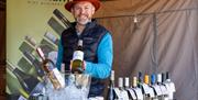 A wine merchant and his stall at the Weston-super-Mare weekly market in the Italian Gardens