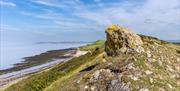 A rocky crag on a hill overlooking the sea