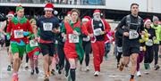 Runners in Christmas fancy dress set off at the start of the Weston-super-Mare Christmas Cracker Race on the town's beach