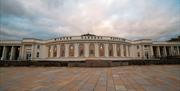 Outside view of an elegant ballroom with a large paved area in the foreground