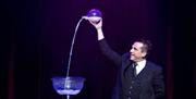 Magician Danny Hunt performing a magic trick