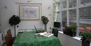 Bridge Hall Apartments Visit Weston-super-Mare self catering accommodation conservatory interior dining table house plants windows