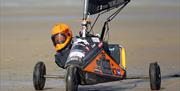 Close up of a blokart racer in his three wheeled kart