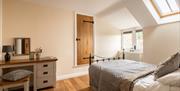 A luxury bright and airy double bedroom in the loft room of a country cottage at Webbington Farm Holiday Cottages near Weston-super-Mare. The room fea