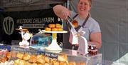 A market stall holder putting a cake into a bag at the Weston-super-Mare weekly market