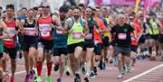 A large group of runners in a half marathon