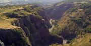 Looking down into a valley from the top of a gorge