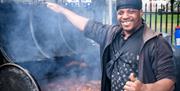 Man cooking jerk chicken at St Pauls Carnival