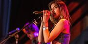 A female singer performing on stage during the Incider Festival at the Sand Bay Holiday Village, Weston-super-Mare