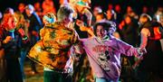 A male and female dancing in the crowd at the Mendip Family Festival