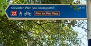 A blue way marker side advertising a cycle route