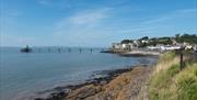 A coastal scene with a pier and town of Clevedon