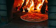 Enjoy tasty wood-fired pizzas