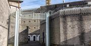 High walls and fencing of a prison entrance