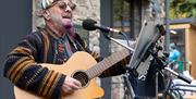 A guitarist sings into a microphone during a performance at the Old Town Quarry, Weston-super-Mare