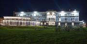 Exterior of a palatial hotel lit up at night