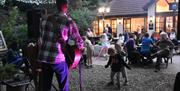 Sam Evans on stage  with children dancing in front