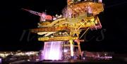 The SEE Monster art installation, a giant North Sea oil platform illuminated at night