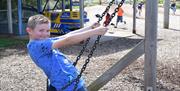 On a swing at Puxton Park