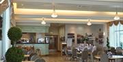 Interior of a restaurant with wooden floor and tables