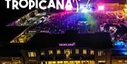 Aerial view of the Tropicana night time venue all lit up with disco lights
