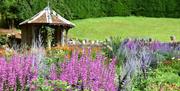 Lilac land in a garden with a round turret building in the background