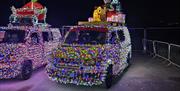 Two VW vans covered in Christmas fairy lights