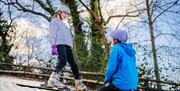 Young girl learning to ski with Mendip Activity Centre instructor.