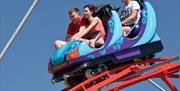 3 people in a car on the rollercoaster