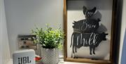 Potted plant and a picture on a shelf