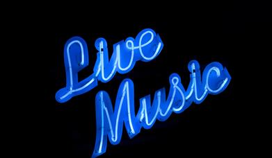 A neon blue sign on a black background saying Live Music