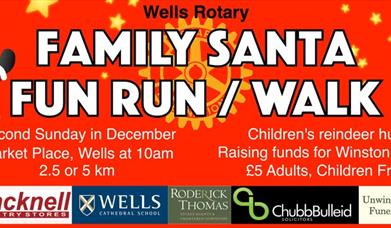 Red poster featuring a Santa and a reindeer to advertise Wells' Rotary Family Santa Run
